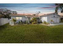 House exterior at dusk with well-maintained lawn at 10264 Oakhurst Rd, Largo, FL 33774