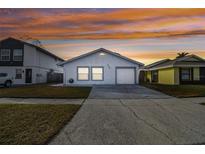Updated single-story home with attached garage and well-manicured lawn at 10323 Del Mar Cir, Tampa, FL 33624