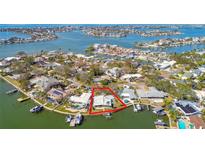 Aerial view of waterfront property with large lot and boat dock at 1897 Clearwater Harbor Dr, Largo, FL 33770