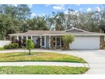 Single-story house with attached garage and manicured lawn at 1903 Oro Ct, Clearwater, FL 33764