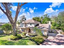 Two-story house with landscaped yard, brick driveway, and large tree at 2752 Buckhorn Oaks Dr, Valrico, FL 33594