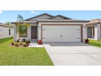 One-story house with attached garage and landscaped front yard at 29603 Fedora Cir, Brooksville, FL 34602