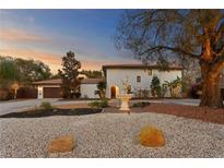 Stunning home features a lovely front yard, beautiful landscaping, and a charming water fountain at 403 Weeburn Rd, Temple Terrace, FL 33617