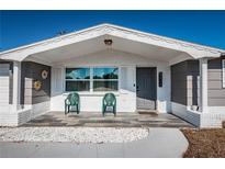 Inviting front porch seating area with white rock and tile at 5405 Golden Nugget Dr, Holiday, FL 34690