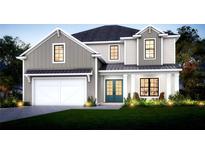 Charming two-story home with modern farmhouse design, manicured lawn, and inviting curb appeal at 5703 S Macdill Ave, Tampa, FL 33611