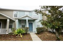 Two-story townhome with light blue exterior and a blue front door at 1552 Blue Magnolia Rd, Brandon, FL 33510