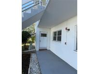 Exterior view of condo building, showing walkway, landscaping, and building exterior at 5895 18Th N St # 9, St Petersburg, FL 33714