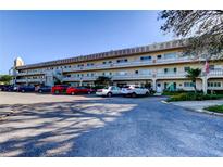 A condominium building showcases a well-maintained exterior with ample parking and manicured landscaping at 2284 Philippine Dr # 71, Clearwater, FL 33763