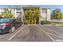 Exterior view of condo building with parking and landscaping at 304 S Habana Ave # A3, Tampa, FL 33609