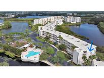 Aerial view of waterfront condo building with pool and lush landscaping at 6315 Shoreline Dr # 3208, St Petersburg, FL 33708