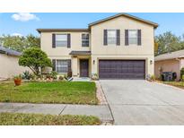 Two-story house with a two-car garage and landscaped lawn at 14003 Fareham Rd, Odessa, FL 33556