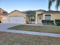 Beautiful two-story house with a two-car garage and well-manicured lawn at 16103 Muirfield Dr, Odessa, FL 33556