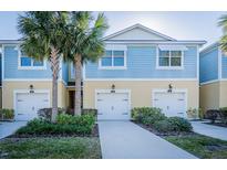 Inviting townhome community with two-car garages, mature landscaping, and a well-maintained exterior at 1708 Sunset Wind Loop, Oldsmar, FL 34677