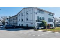 Exterior view of a two-story building with parking at 400 Glennes Ln # 108, Dunedin, FL 34698