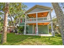 Two-story home with a covered porch, wood ceilings, and a well-manicured front lawn at 5644 Missouri Ave, New Port Richey, FL 34652