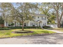 Two-story house with gray shutters, landscaping, and a walkway at 620 26Th N Ave, St Petersburg, FL 33704