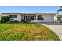 Charming ranch home with well-manicured lawn and attached garage at 9548 141St St, Seminole, FL 33776