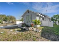 Charming exterior featuring updated siding, landscaping, and a decorative water feature in the front yard at 2070 28Th St, Sarasota, FL 34234