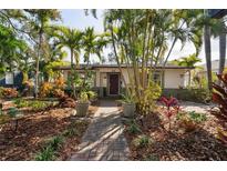 Cute bungalow home with lush landscaping and a brick walkway at 216 23Rd N Ave, St Petersburg, FL 33704