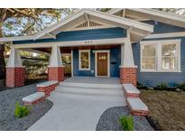 Charming craftsman home with blue siding, brick accents, and a covered porch at 409 E Adalee St, Tampa, FL 33603