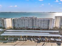 Aerial view of a waterfront building with parking and bay views at 6020 Shore S Blvd # 101, Gulfport, FL 33707