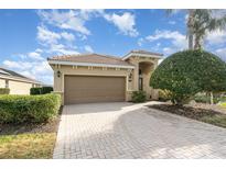 Single-story home with a large driveway and well-maintained landscaping at 207 Winding River Trl, Bradenton, FL 34212