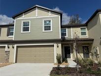 Charming two-story townhouse with a two-car garage and neutral-toned siding at 36189 Joseph Blake St, Zephyrhills, FL 33541