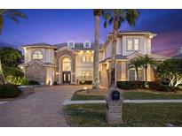 Elegant two-story home with brick accents and palm trees at 5308 E Longboat Blvd, Tampa, FL 33615