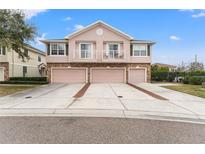 Three-unit townhome building with attached garages and landscaping at 535 52Nd N Ave, St Petersburg, FL 33703