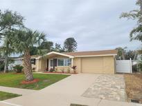 Updated single-story home with a new driveway and landscaping at 5611 Riddle Rd, Holiday, FL 34690