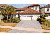 Two-story house with tile roof, three-car garage, and landscaped yard at 6648 Sunset Vista Way, Land O Lakes, FL 34637