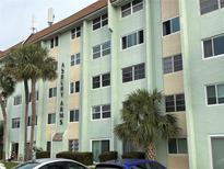 Multi-story condominium building with well-maintained landscaping and palm trees at 801 83Rd N Ave # 217, St Petersburg, FL 33702