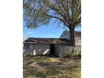 Charming single-story home featuring neutral-colored walls, a well-maintained lawn, and a beautiful, mature shade tree at 8608 Lake Isle Dr # 0, Temple Terrace, FL 33637