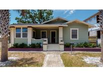 Charming bungalow with a green facade, porch, and well-maintained landscaping at 2418 2Nd S Ave, St Petersburg, FL 33712