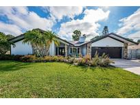 Beautiful mid-century modern home with landscaped lawn and updated facade at 2973 Somersworth Dr, Clearwater, FL 33761