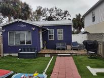 Cute purple house with a deck, small fenced yard, and artificial turf at 5266 6Th S Ave, St Petersburg, FL 33707