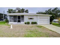 Single-wide manufactured home with carport and small lawn at 6125 Alpine Dr, Zephyrhills, FL 33542