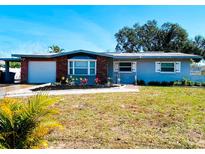 Charming single-story home with a well-maintained lawn and colorful landscaping at 12361 114Th St, Largo, FL 33778