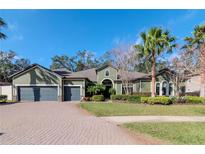 Beautiful two-story home with a three-car garage and lush landscaping at 13904 Shadow Tree Ln, Tampa, FL 33618