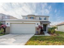 Two-story house with attached garage and landscaping at 18840 Parapet Pl, Land O Lakes, FL 34638