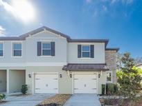 Two-story townhome with two-car garage and stone accents at 30822 Veridian Way, Wesley Chapel, FL 33543