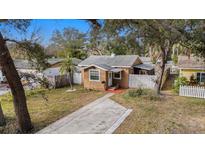 Charming bungalow with a spacious yard and driveway, nestled amongst lush trees at 5251 39Th N Ave, St Petersburg, FL 33709