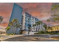 Condo building exterior, waterfront views, palm trees, sunset at 644 Island Way # 206, Clearwater, FL 33767