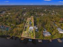 Beautiful aerial view of a waterfront property with lush landscaping and defined property lines at 906 W Henry Ave, Tampa, FL 33604