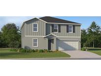 Two-story house with gray siding, black shutters, and a two-car garage at 13007 Calcite Blue Ave, Wimauma, FL 33598