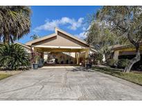 Exterior view of condo with carport and landscaped grounds at 170 Eric Ct, Oldsmar, FL 34677