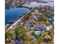 Stunning aerial view of waterfront home featuring lush landscaping, a private pool, and boat access at 2186 Coffee Pot Ne Blvd, St Petersburg, FL 33704