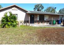 Modest single story home featuring a covered porch and stone accent, showing an opportunity for creative curb appeal at 6567 S West Shore Cir, Tampa, FL 33616