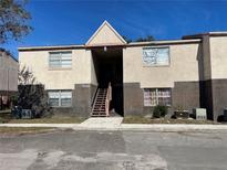 Tan colored two-story building with brick accents and multiple units at 9011 Westchester Cir # 24, Tampa, FL 33604