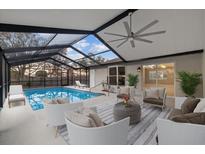 Relaxing pool area with covered patio and seating at 11162 Libby Rd, Spring Hill, FL 34609